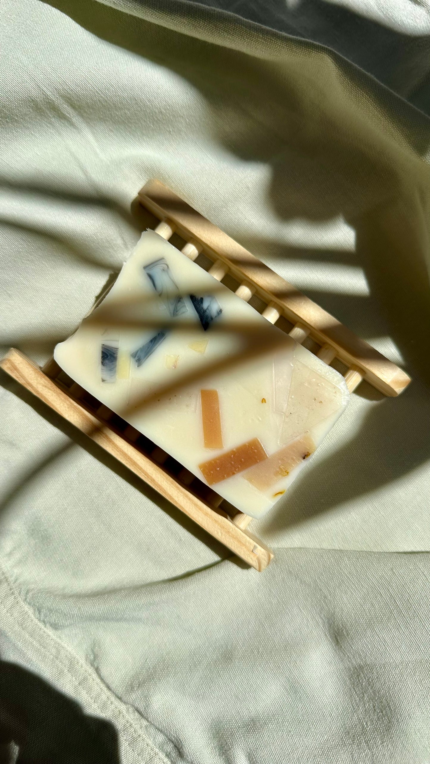 Small wooden stand with rectangular items on a textured surface