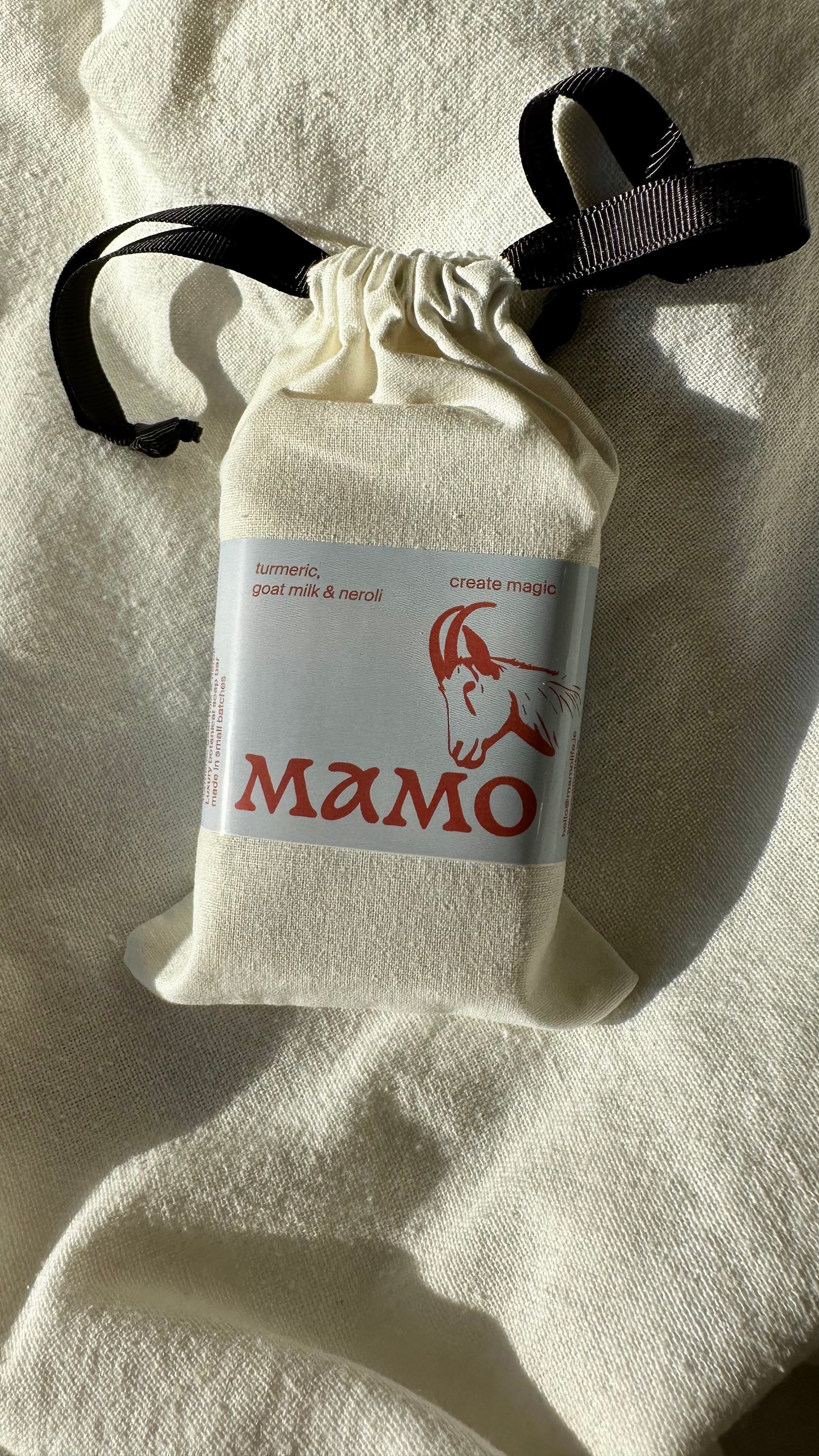 Cold-processed goat milk soap bar with turmeric infusion oil and calming neroli scent
