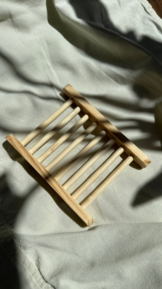 Small wooden stool on a light-colored fabric surface
