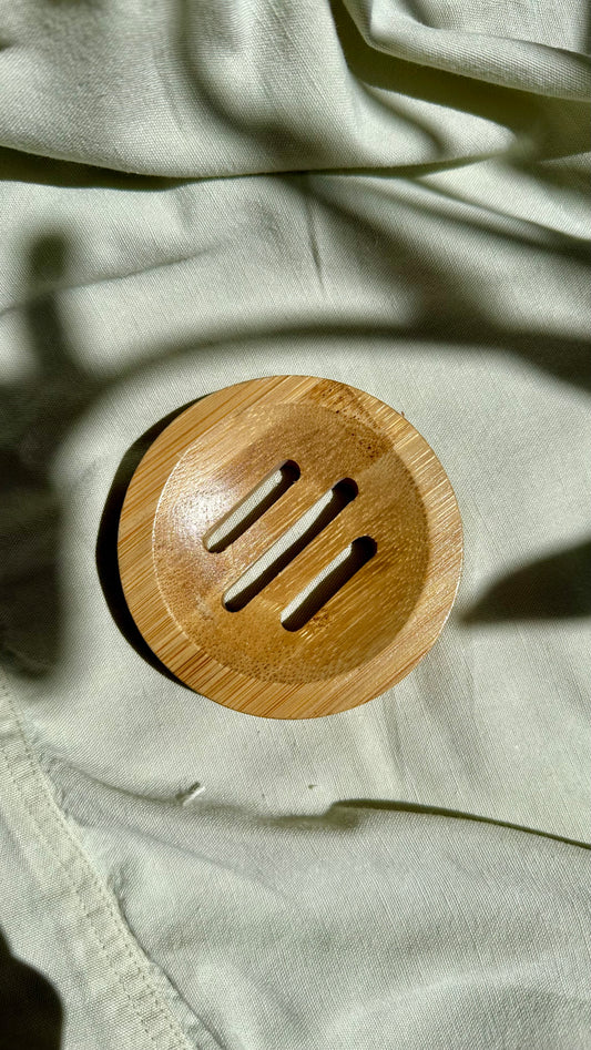 Wooden circular object with slits on a textured fabric background