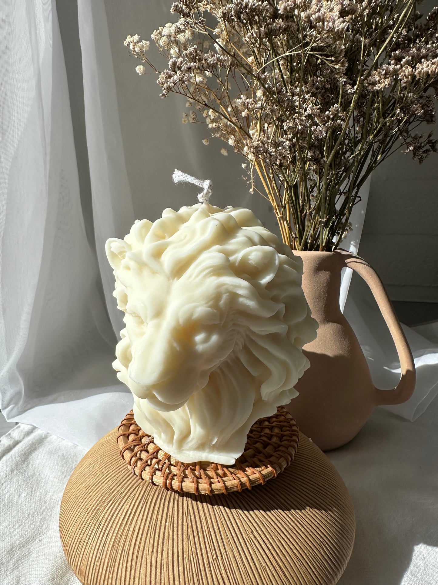 Lion Candle on wood and linen next to a window dreamy modern decor