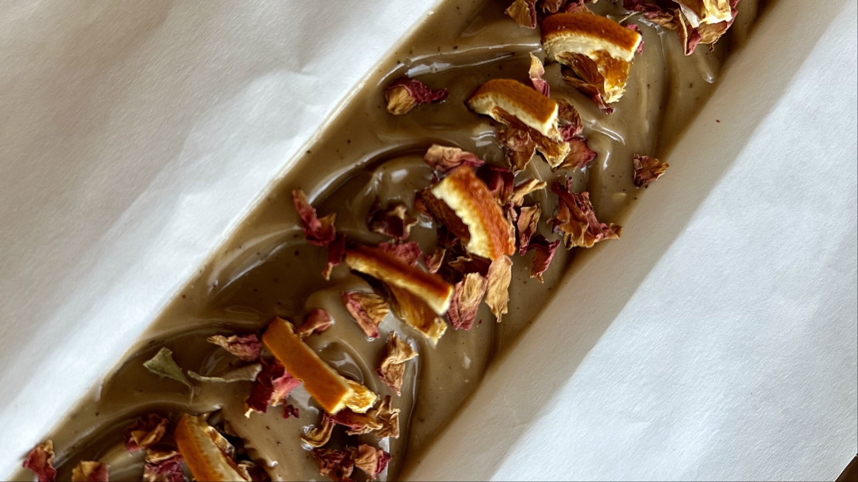 Close-up of a dessert with dried fruit and chocolate sauce on a white plate.