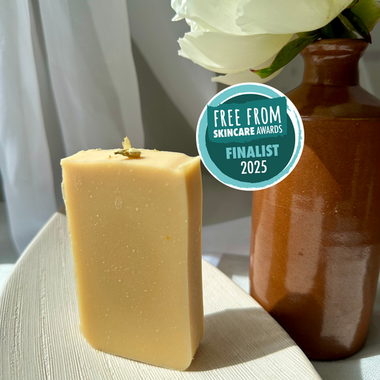 Create Magic goat milk and turmeric soap bar by MAMO, luxury skincare for dry skin on a ceramic plate