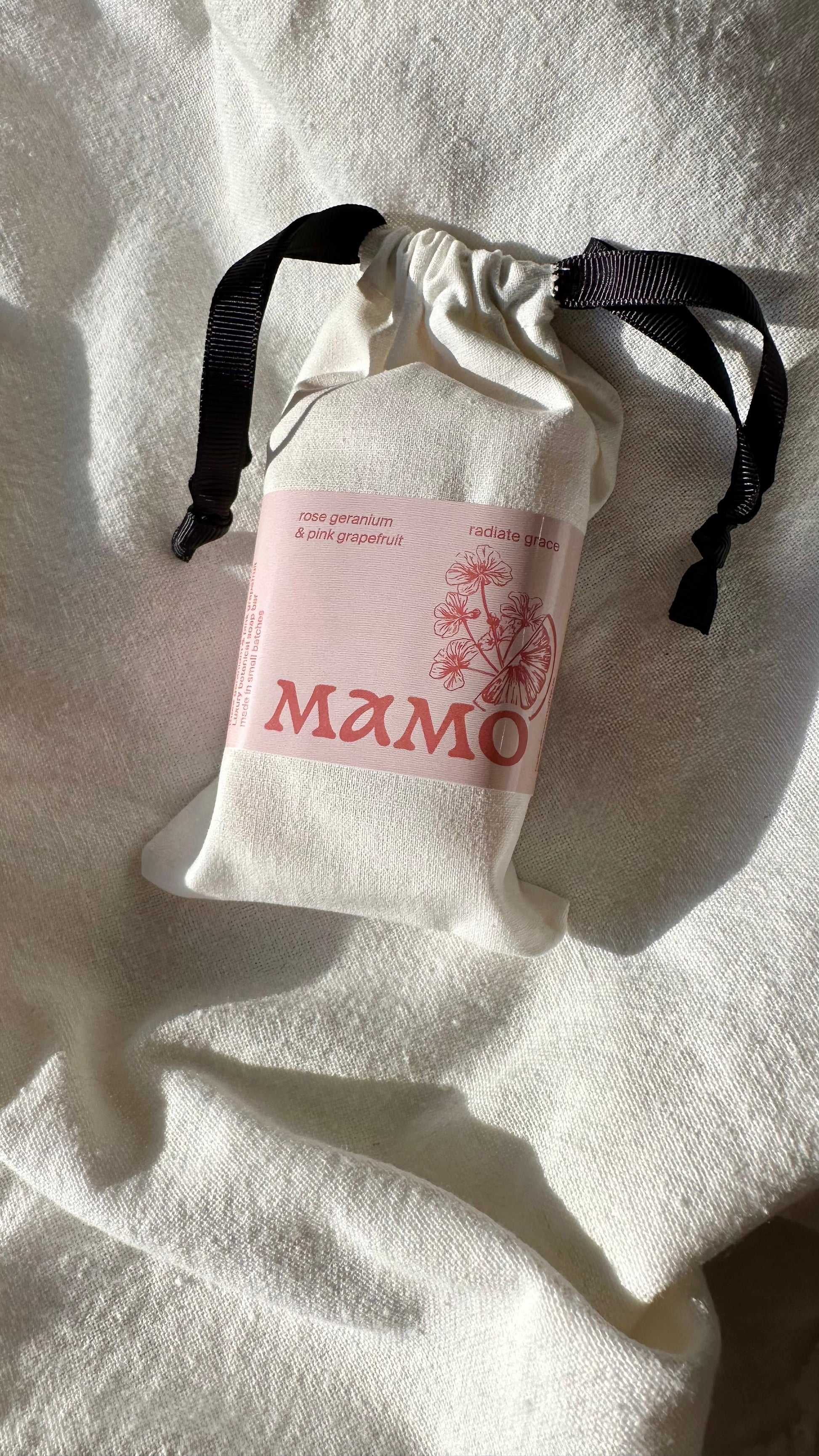 Plastic-free luxury body soap with rose and pink grapefruit scent on linen in a cotton bag
