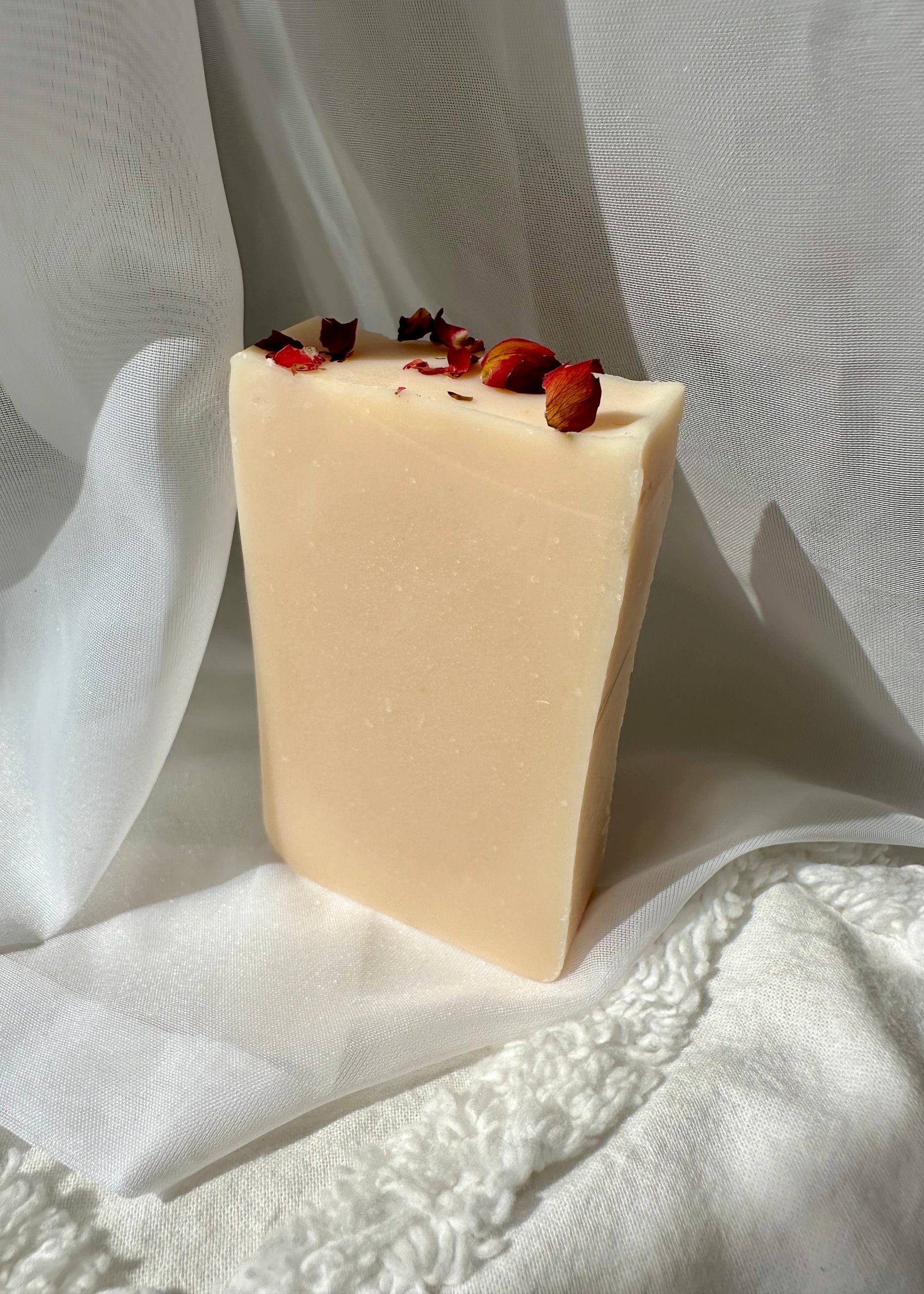 Close-up of floral citrus cold process soap with pink clay